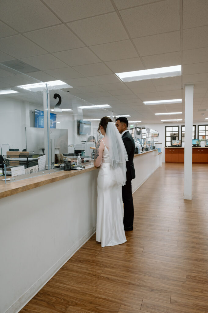 A bride and groom at the clerk's counter at the courthouse