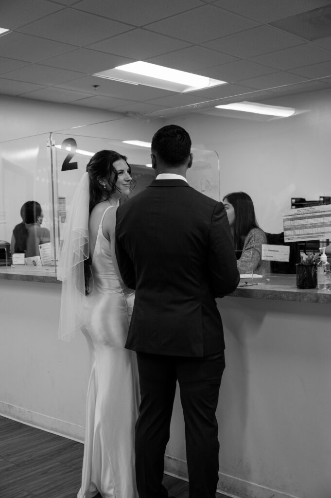 A bride and groom at the Clerk's counter getting their marriage license before their ceremony at Laguna Hills Civic Center
